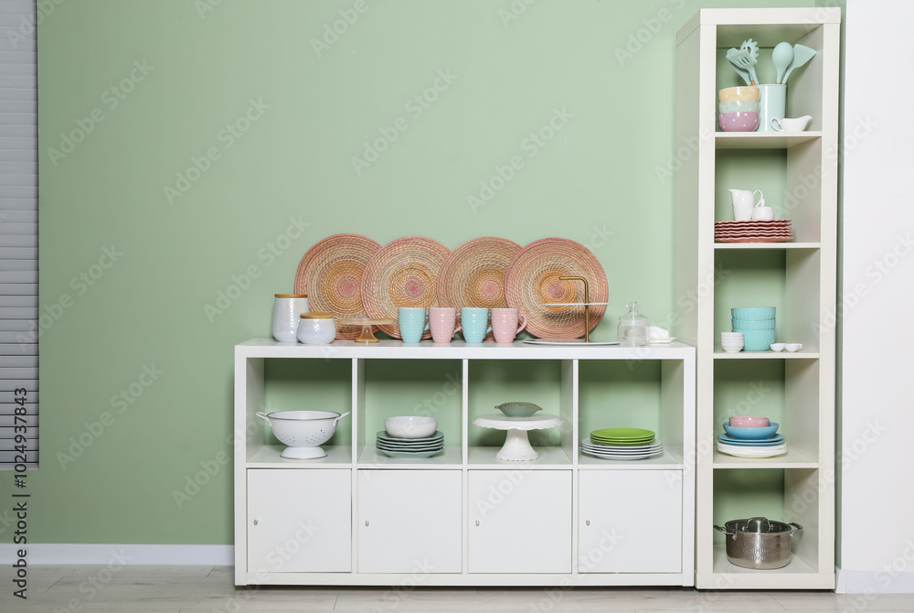 Canvas Prints Shelving unit and storage cabinet with kitchenware near green wall