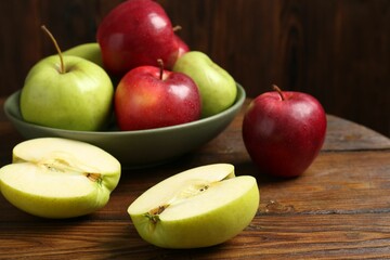 Fresh red and green apples on wooden table