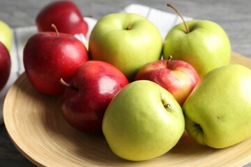 Fresh red and green apples on grey table, closeup