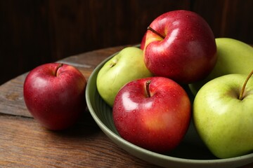 Fresh red and green apples on wooden table, closeup