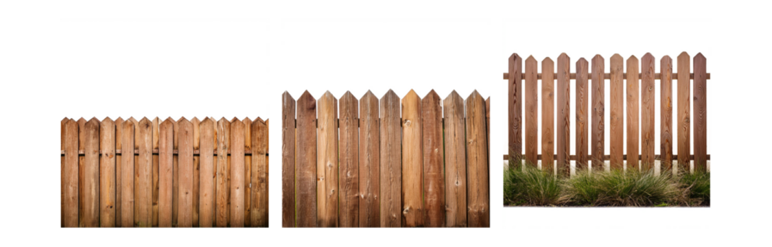 A wooden fence with pointed tops, partially obscured by a patch of grass.