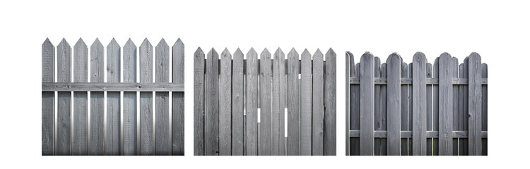 Fototapeta premium A weathered, gray wooden fence with pointed and rounded top slats.