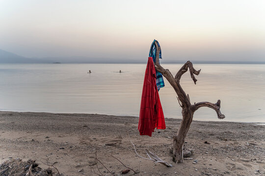 Workers from the salt mining industry washing and swimming in lake afrera at sunset, Danakil Depression, Afar Region, Ethiopia
