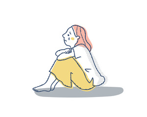 膝を抱えて泣いている女性