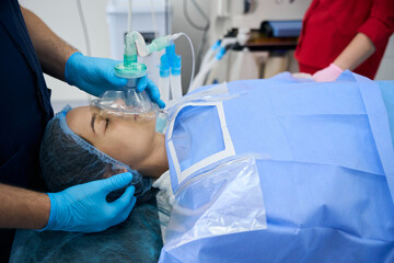 Young woman under anesthesia on the operating table