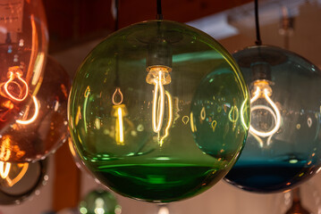 Green spherical lamp hanging from the ceiling with cozy light