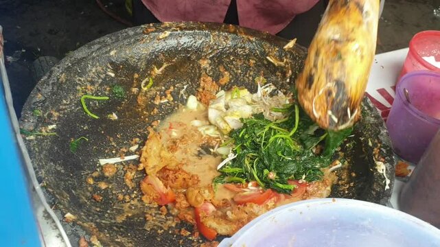 Lotek is a food made from vegetables covered in peanut sauce.