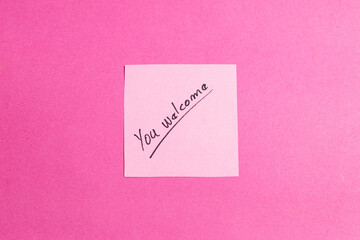 A pink background with a pink sticky note that says 