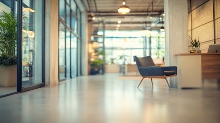 Modern office lobby with sleek design, featuring a lone armchair, large windows, and potted plants, creating a bright and inviting professional atmosphere.