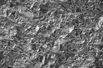 Processed collage of shiny metal silver gray foil crumpled packaging material texture