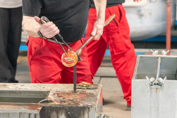 Glassmaker working on a glass bulb