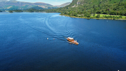 Fototapeta premium Aerial view of a boat sailing on a lake, United Kingdom