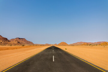 Driving on a new modern asphalt road in Damaraland, road perspective in the desert, Namibia, Africa