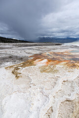 Stunning Landscape of Yellowstone National Park's Geothermal Basin in Wyoming, USA with Majestic Clouds and Unique Terrain