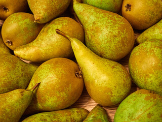 Pile of green pears on wooden table
