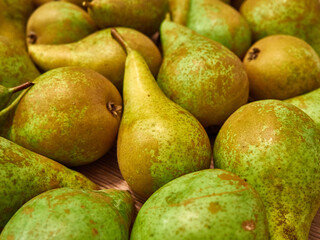 Pile of green pears on wooden table