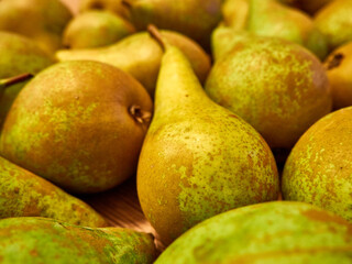 Pile of green pears on wooden table