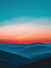 Vivid sunrise over layered mountain ranges, casting a gradient from deep blue to fiery orange in the sky, creating a tranquil and breathtaking landscape.