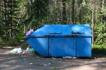 blue trash can at the forest