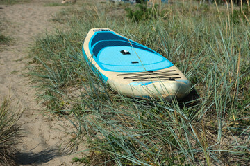 blue SUP board on the grass