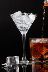 Cocktail with ice on black. Wine glasses with ice. Shallow depth of field