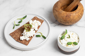 Homemade crispy toasts with ricotta, cottage cheese and herbs, 
microgreens, healthy eating, food for athletes