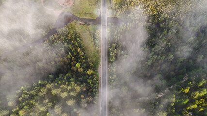 A truck and cars are driving along a beautiful road