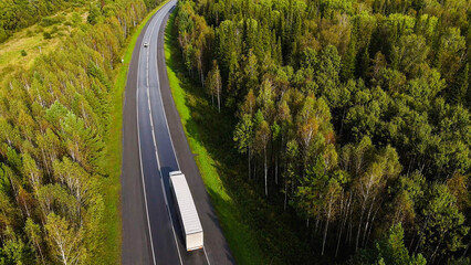 A truck and cars are driving along a beautiful road © Павел Чигирь