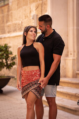 Naklejka premium Couple in love embracing on a street in Menorca