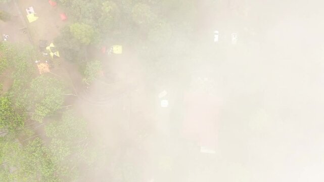 aerial top view of the cool mist of the campsite in the valley of the hill
