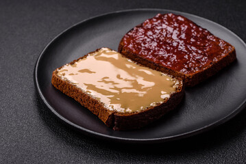 Sandwiches with toast bread, peanut butter and raspberry or strawberry jam