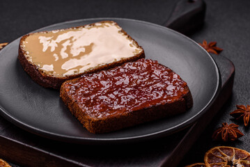 Sandwiches with toast bread, peanut butter and raspberry or strawberry jam