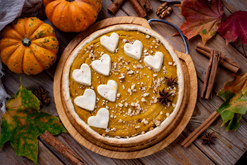 Delicious pumpkin pie on a wooden table. Pumpkin dessert. American pumpkin pie. A sweet breakfast. close-up