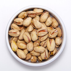 Pistachio nuts in shells in round container