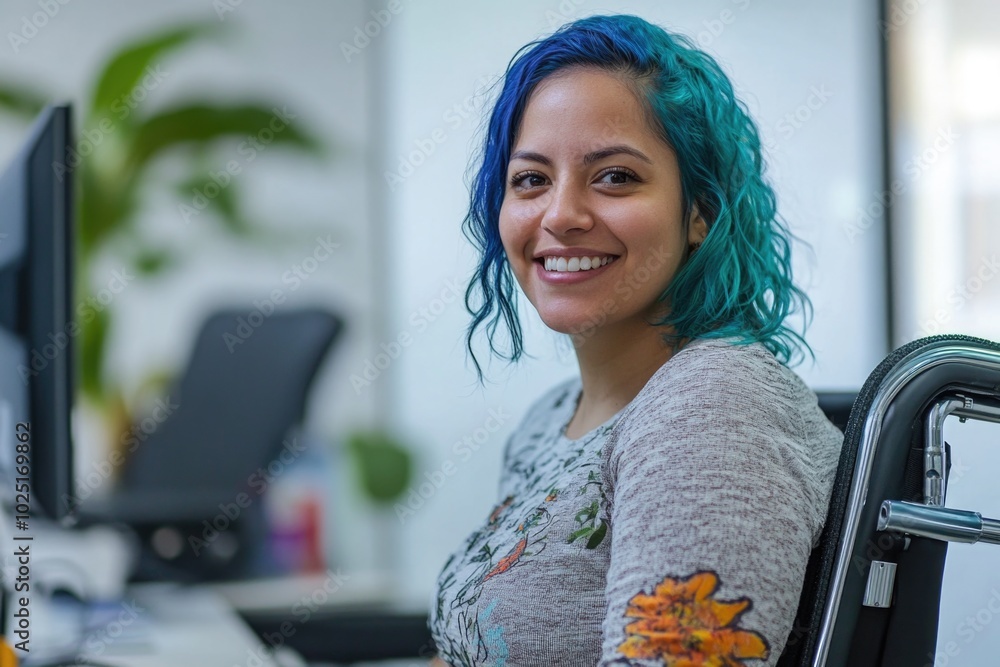 Poster A young woman sits in front of a computer, her bright blue hair standing out against the neutral background