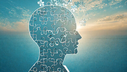 Creative depiction of a human head formed by puzzle pieces against a tranquil sunset over still water