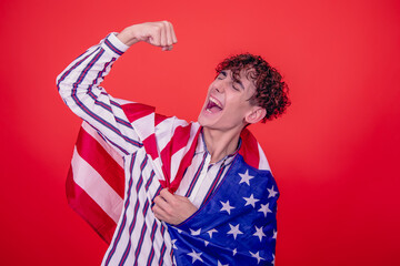 Young attractive guy with national flag. Red background.