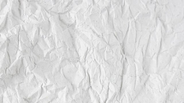 Animation of a white, crumpled sheet of paper in grunge style, looping video, paper animated background. Stop motion