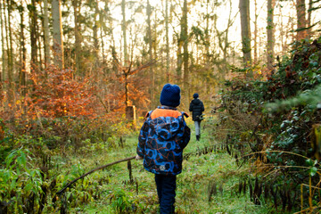 Naklejka premium children walking in the forest