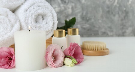 Composition with different spa supplies on white table, closeup