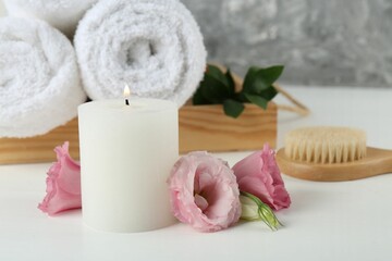 Composition with different spa supplies on white table, closeup