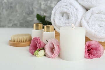 Composition with different spa supplies on white table, closeup
