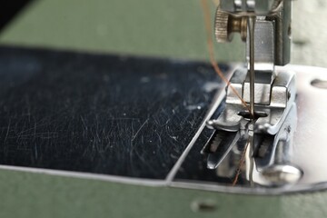 Professional sewing machine on blurred background, macro view