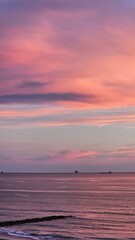 Pink sunset in the sea and mountains, beautiful clouds color