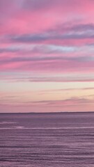 Naklejka premium Pink sunset in the sea and mountains, beautiful clouds color