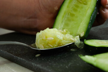 Close-up of a woman's hands peeling and cutting vegetables with a knife on a cutting board. Concept of home cooking, gastronomy, veganism.