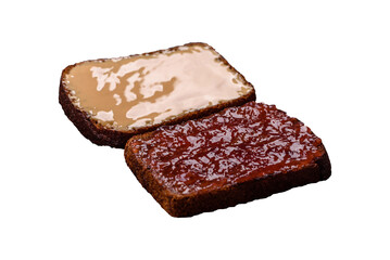 Sandwiches with toast bread, peanut butter and raspberry or strawberry jam