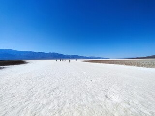 death valley landscape, salt lake view, panorama, people silhouette in the distance