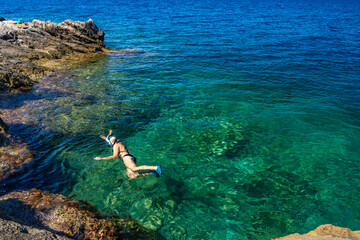 A shapely girl swims in the Adriatic Sea off the coast of Croatia