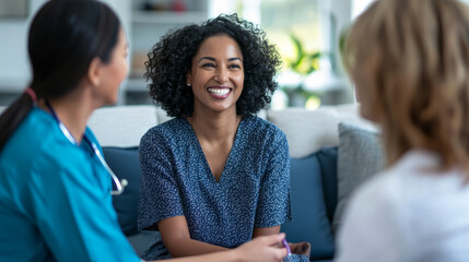 Staff members providing emotional support to a smiling patient during a counseling session in a bright therapy room